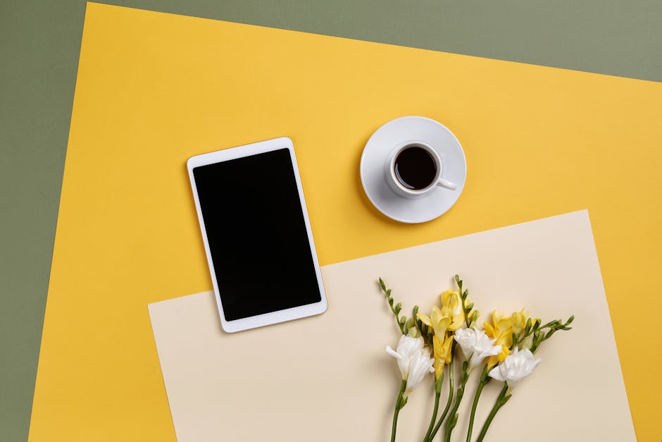 A group of diverse professionals collaborating in a modern office setting with laptops and technology.