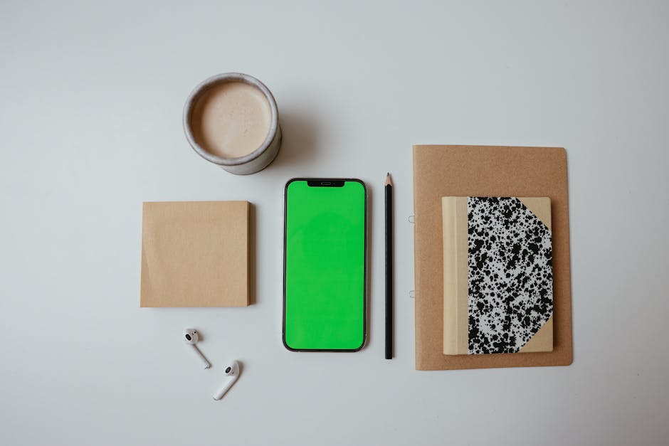 A diverse group of professionals working together on laptops in a modern office meeting room.