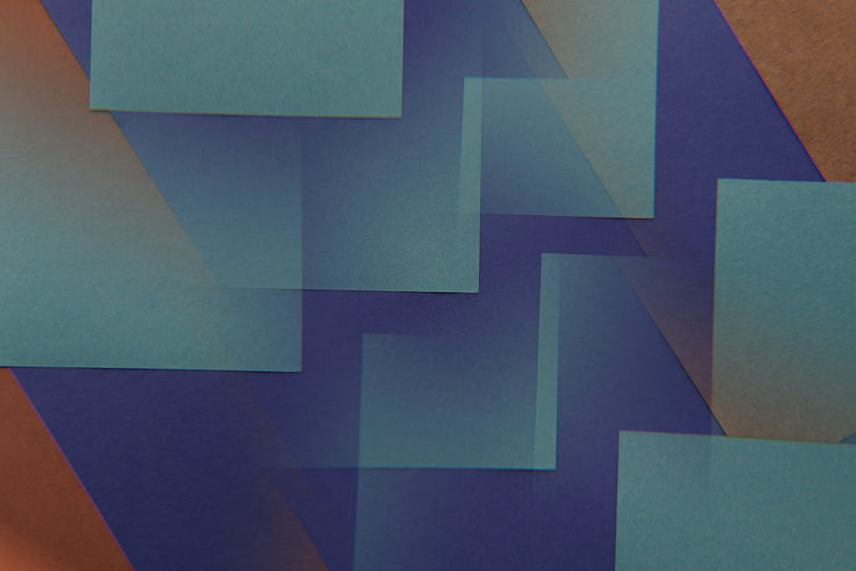 A sleek and modern office desk setup featuring an iMac, iPad with calendar, keyboard, and mouse.