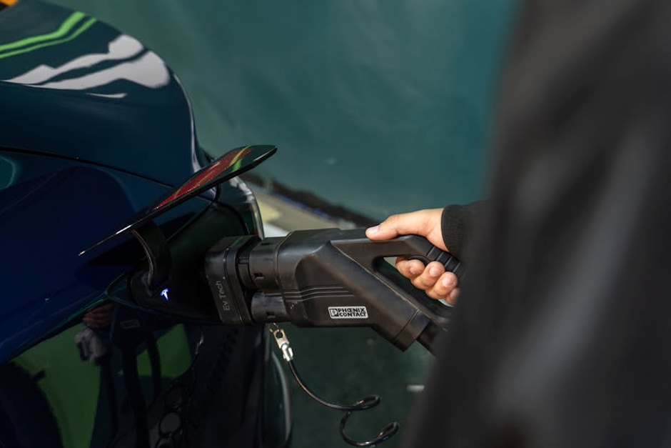 Close-up of an electric vehicle being charged at a station.