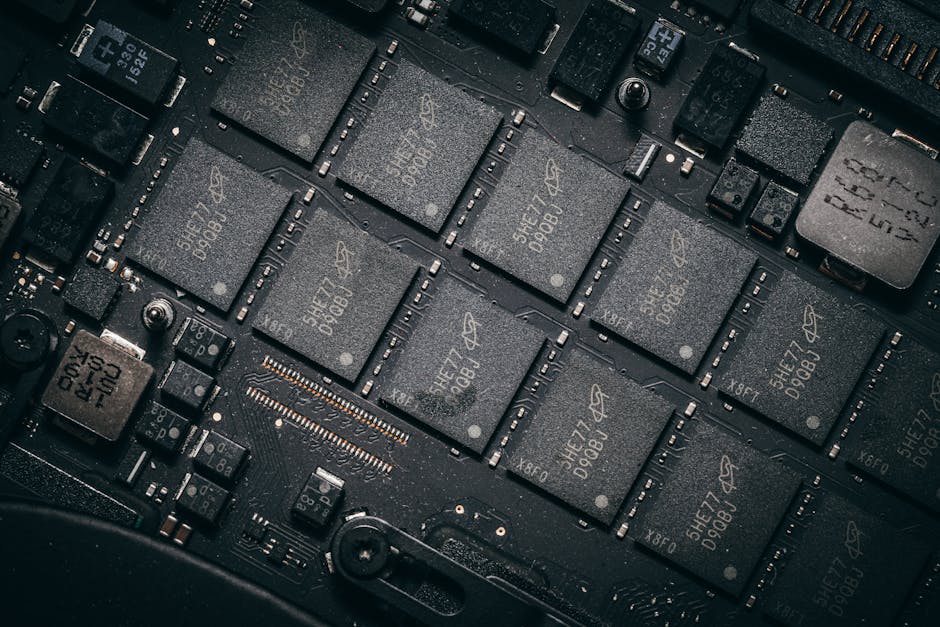 Detailed view of electronic circuit board components showcasing microchips and technology intricacies.