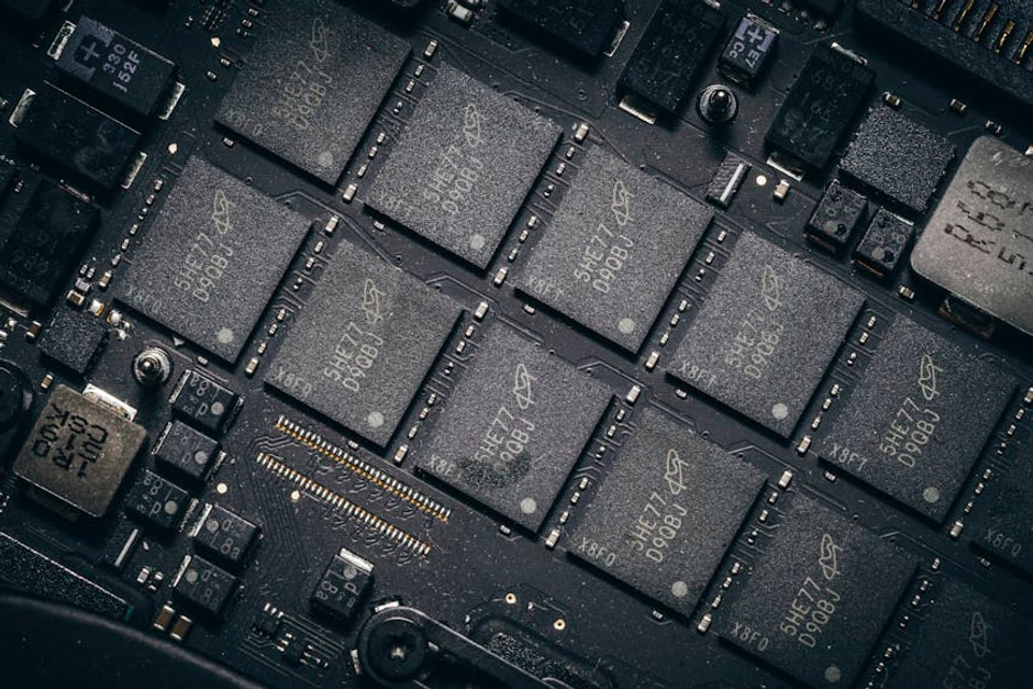 Detailed view of electronic circuit board components showcasing microchips and technology intricacies.