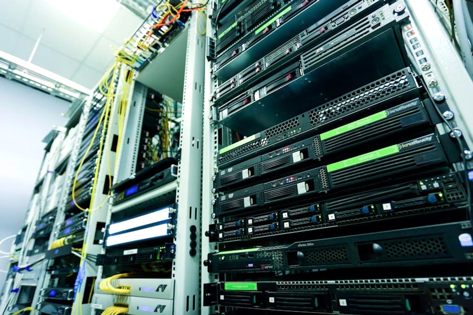 High-tech server rack in a secure data center with network cables and hardware components.