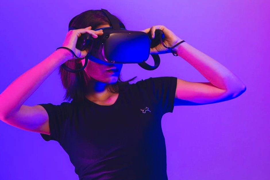 Woman wearing virtual reality headset immersed in a vibrant neon-lit gaming experience.
