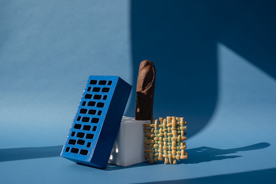 An artistic arrangement of colorful objects on a blue background with creative shadows.