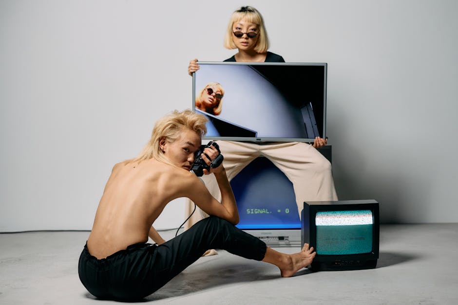 Stylish editorial shoot featuring fashionable models with retro TVs and modern aesthetics.