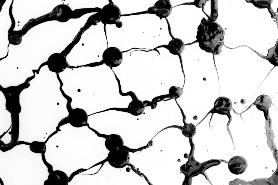 Intricate black ink patterns create a striking abstract design on a white backdrop.