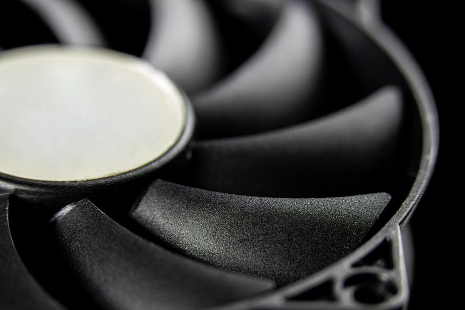 Macro close-up of a modern computer cooling fan blade, showcasing intricate details.