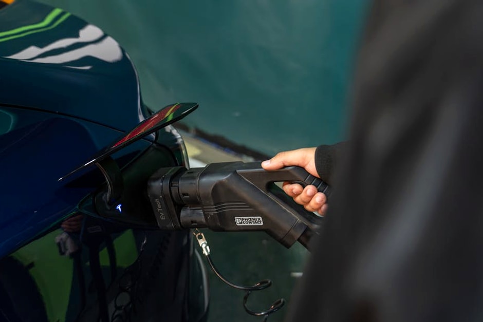 Close-up of an electric vehicle being charged at a station.
