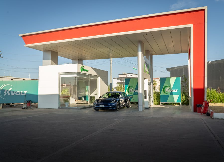 A sleek electric car charging at a modern station with blue skies in the background, promoting eco-friendly travel.