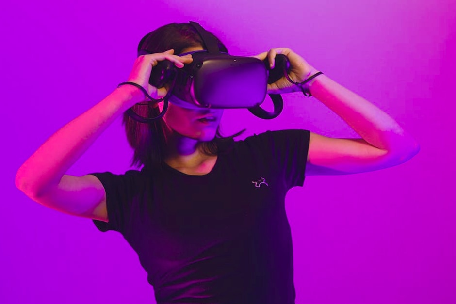Woman wearing virtual reality headset immersed in a vibrant neon-lit gaming experience.