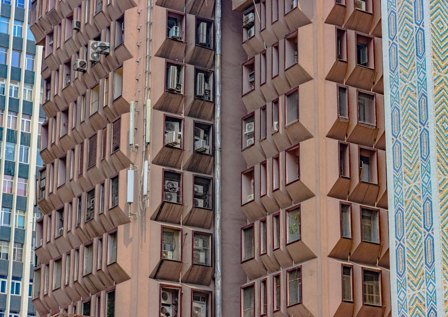 Symmetrical architecture with modern design and air conditioning units in New Delhi, India.