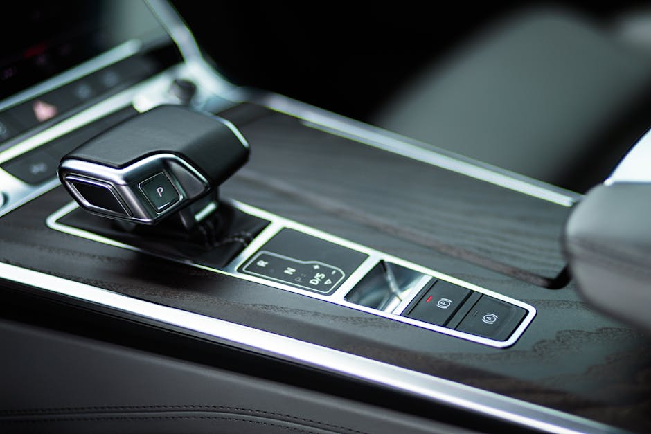 Close-up view of a sleek automatic gearbox in a luxurious car interior.