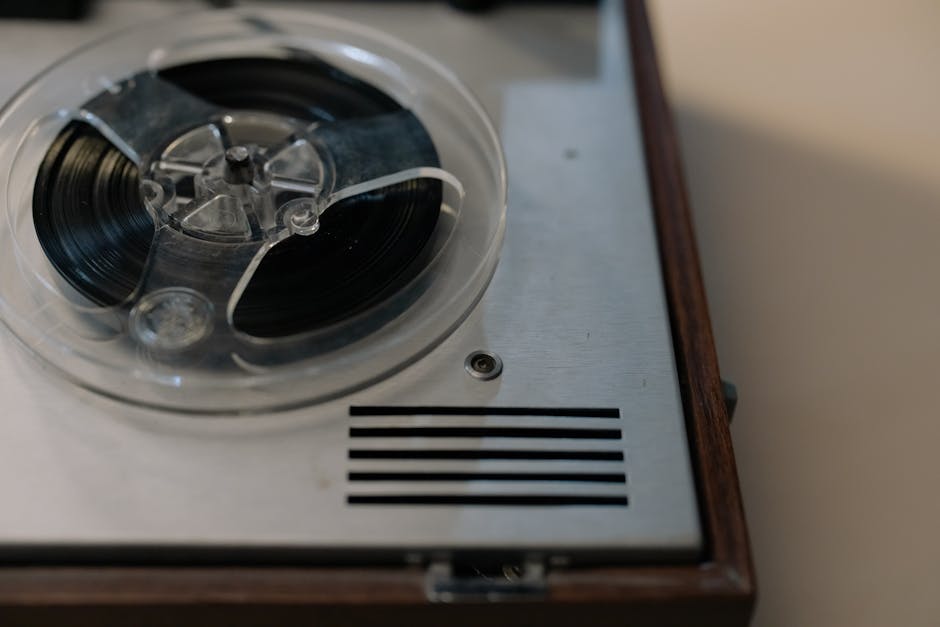 Close-up of a vintage reel-to-reel tape recorder showcasing its intricate details and classic design.