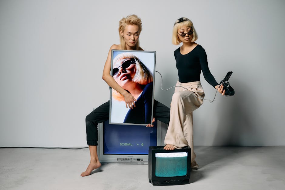 Fashion models posing with vintage electronics in a studio setting, displaying modern chic style.