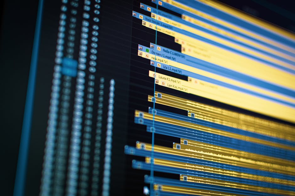 A diverse group of professionals working together on laptops in a modern office meeting room.