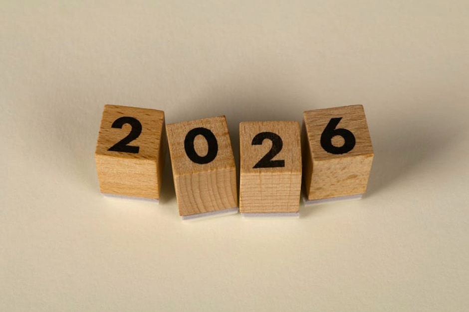 Wooden cubes forming the year 2026 on a neutral background.