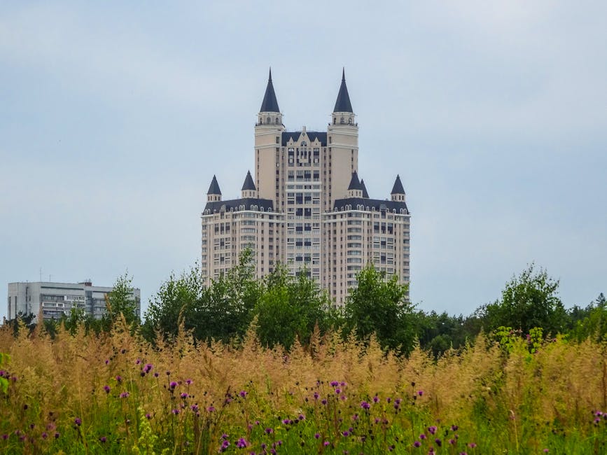 Majestic building with spires in Moscow, viewed from a grassy meadow.