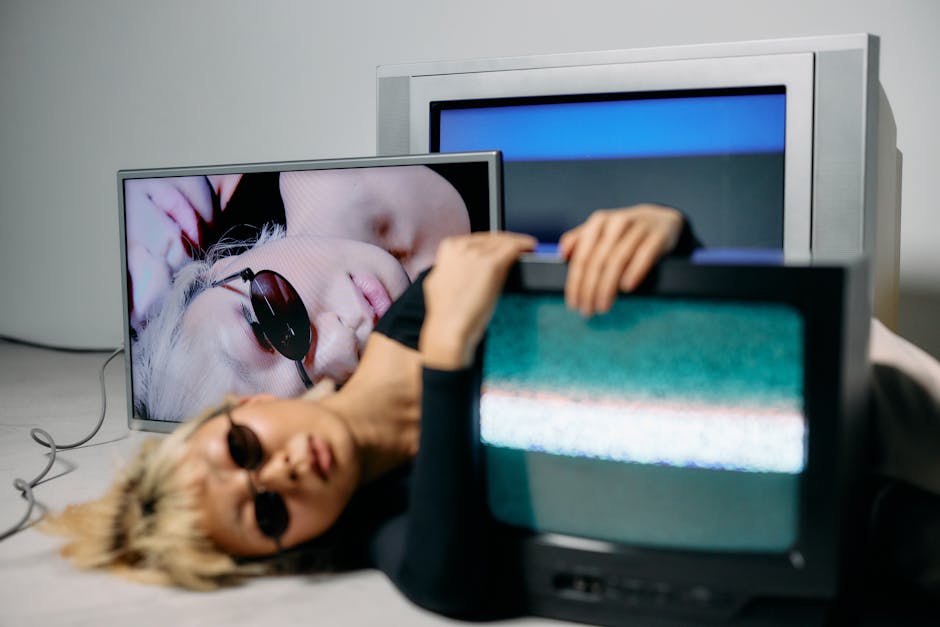 Edgy fashion editorial in a studio setting featuring CRT technology and chic sunglasses.